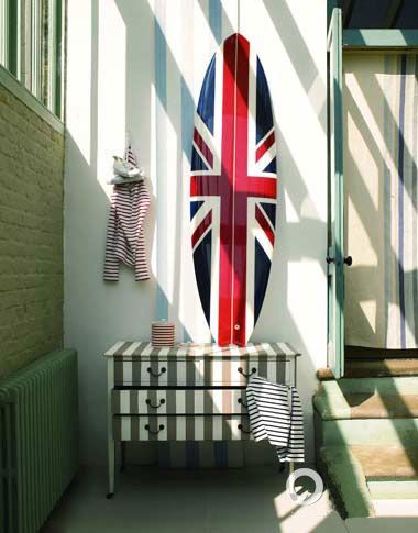 一个灰褐、白色相间的手绘抽屉柜，英国国旗纹样的冲浪板乃至条纹T恤衫和窗外斑驳的日光，都悄悄印证着条纹对空间强大的装饰力和塑造力。