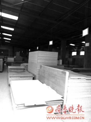 在济南一小型家具加工厂的车间，地面上摆满了木板，老板称他们曾为品牌家具做“代工”。