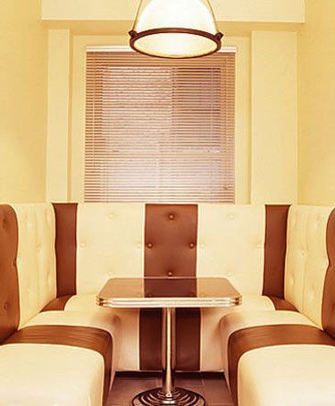 咖啡色的粗条纹设计和带咖啡色的餐厅灯，把这个小空间设计得感觉像一个温馨的茶餐厅