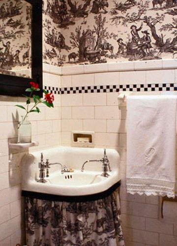 整面墙底部铺有白色墙砖，点缀夸张图案的黑白壁纸，降低了卫浴间的拘束感